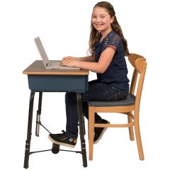 Girl using The Original FootFidget ® Footrest while typing on a laptop at the desk