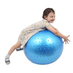 Girl smiling and happily laying over the blue Tactile Sensory Ball